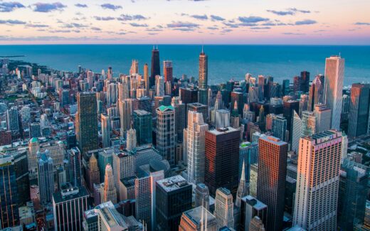 Chicago skyline with towering skyscrapers and the iconic Willis Tower against a clear blue sky